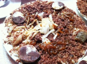 Talas Beshbamark (julienned noodles with crumbled horsemeat, topped with horse intestine rings)