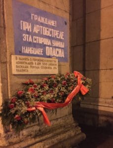 A WWII era sign still preserved on Nevsky Prospect in St. Petersburg. It warns, “Citizens! During shelling this side of the street is most dangerous.” Citizens of St. Petersburg continue to leave flowers by the sign.
