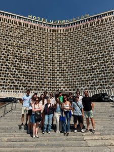 A group photo in front of the Uzbekistan Hotel in Tashkent.